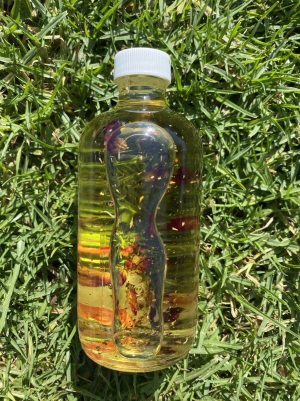 A bottle of water sitting in the grass.