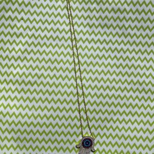 A green and white striped fabric with a button on it.