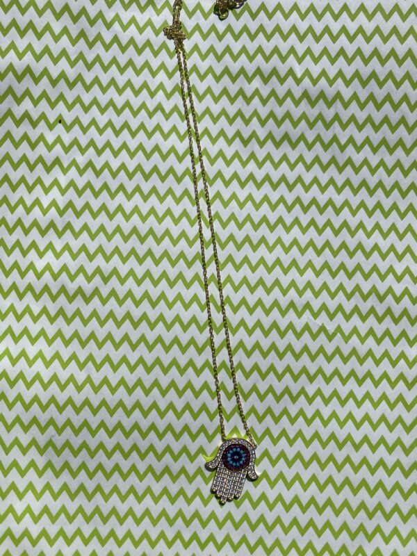 A green and white striped fabric with a button on it.