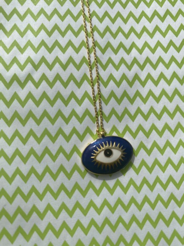 A necklace with an eye on it is hanging from a chain.