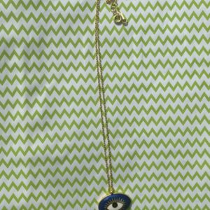 A necklace that is on top of a green and white background.