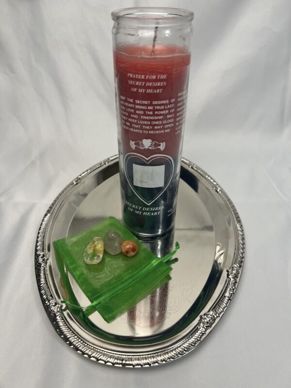 A candle and some green stuff on a silver tray