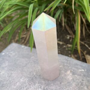 A white crystal sitting on top of a rock.