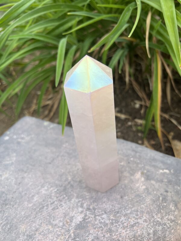 A white crystal sitting on top of a rock.