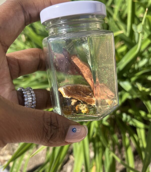 A person holding a jar with some food inside of it