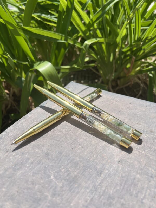 A close up of some green and gold chopsticks