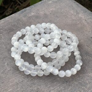 A stack of white beads sitting on top of a table.