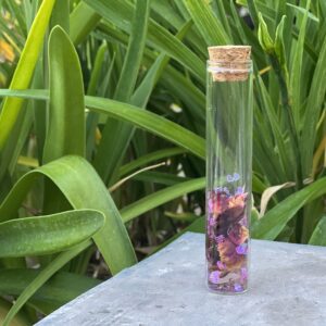 A glass bottle with flowers inside of it