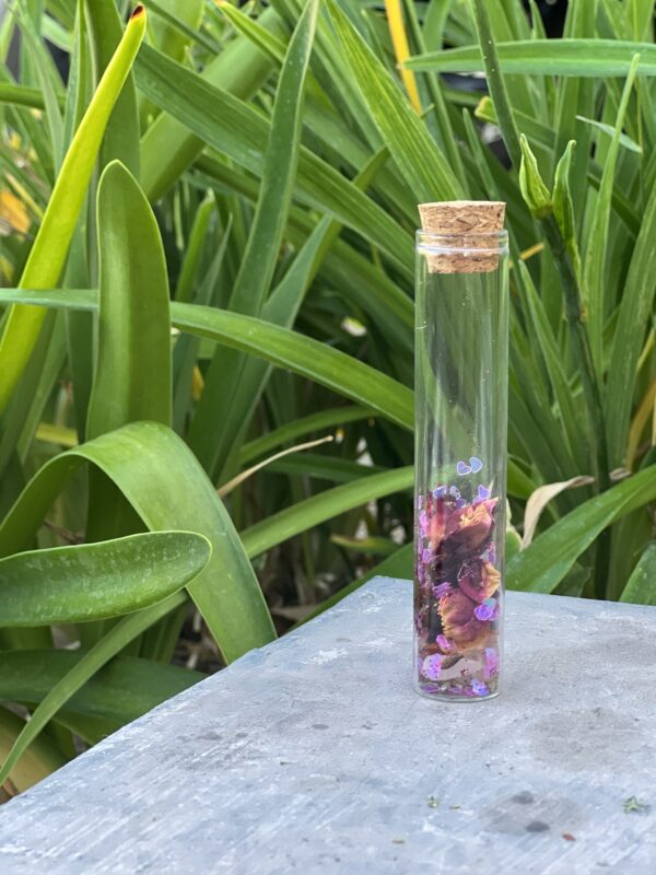 A glass bottle with flowers inside of it