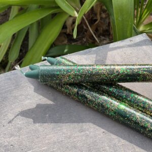 A close up of some green candles on the ground