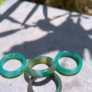 Three green rings sitting on top of a table.