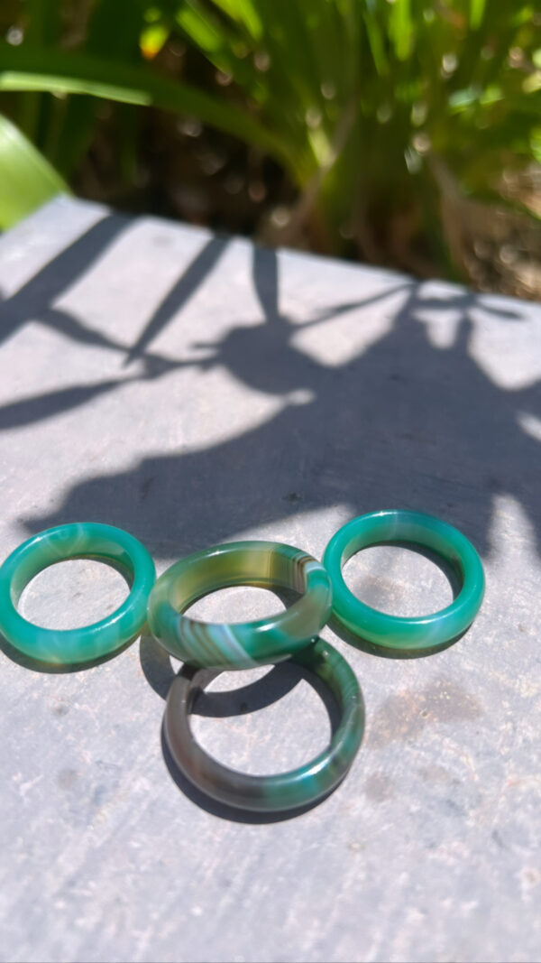 Three green rings sitting on top of a table.