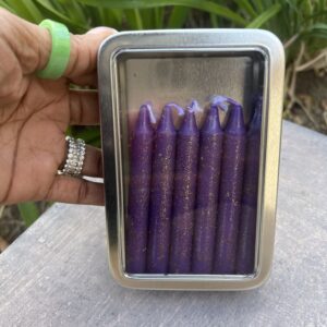 A person holding a box of purple candles.