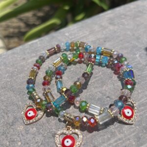 A bracelet with colorful beads and evil eye charms.