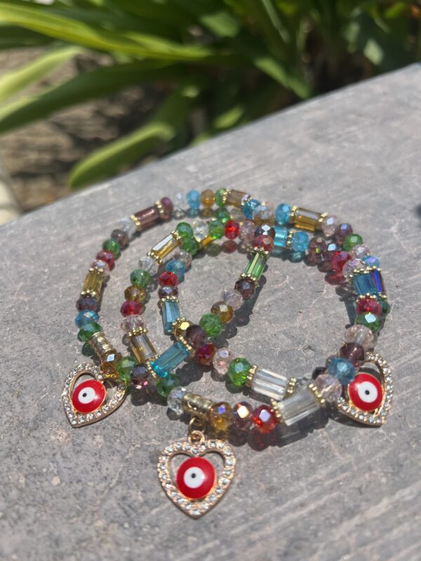 A bracelet with colorful beads and evil eye charms.