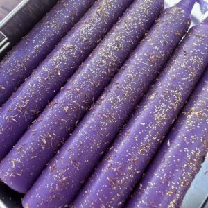 A close up of purple sticks with gold sprinkles