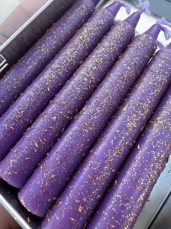 A close up of purple sticks with gold sprinkles