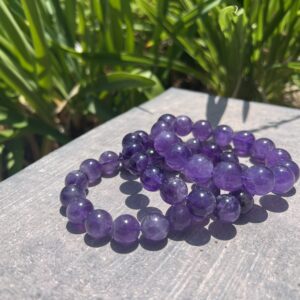 A close up of three bracelets on top of a table