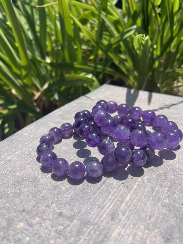 A close up of three bracelets on top of a table