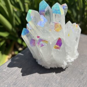 A white crystal with iridescent colors on top of it.