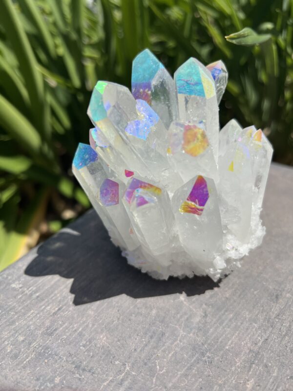 A white crystal with iridescent colors on top of it.