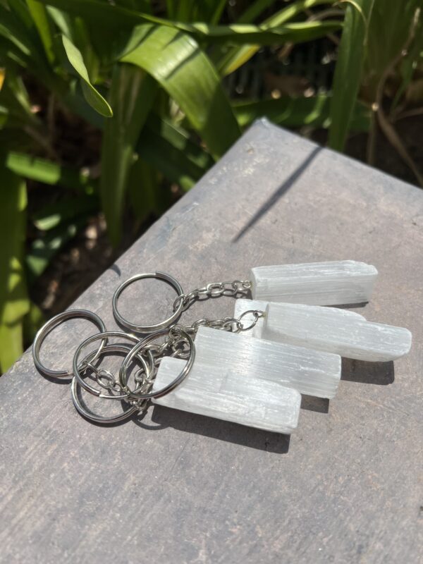 A close up of three key chains on a table