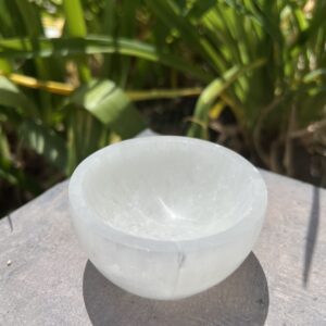 A bowl of white rock on top of a table.