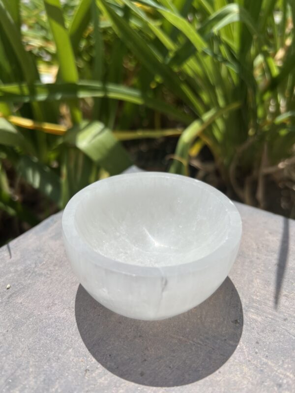 A bowl of white rock on top of a table.