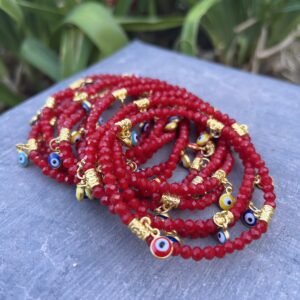 A stack of red beads with gold accents.