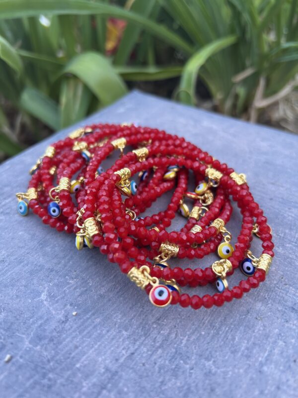 A stack of red beads with gold accents.