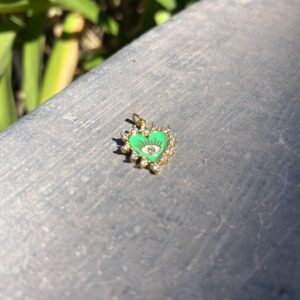 A green and yellow bug sitting on top of a wooden table.