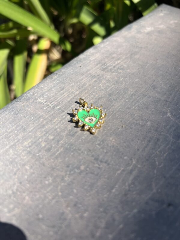 A green and yellow bug sitting on top of a wooden table.