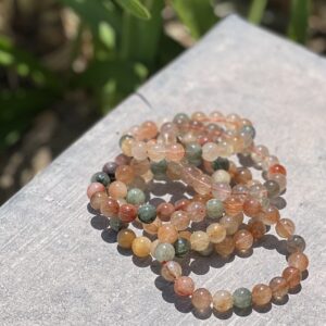 A stack of bracelets sitting on top of a table.