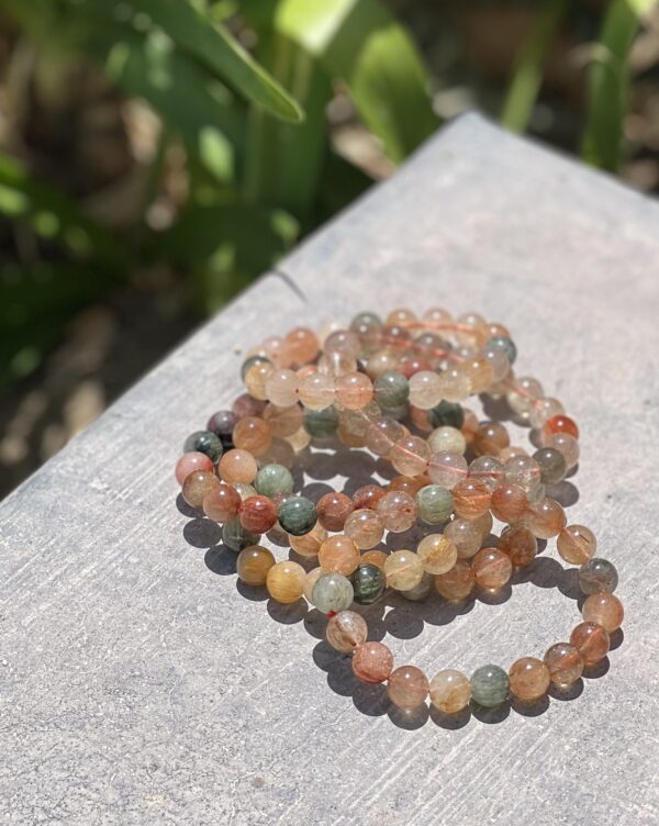 A stack of bracelets sitting on top of a table.