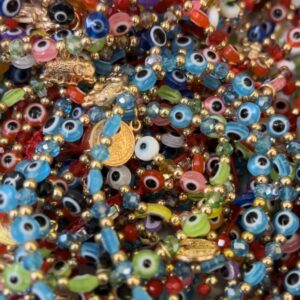 A pile of colorful beads with evil eye charms.