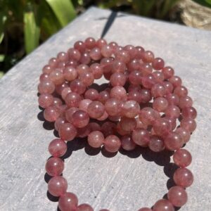 A stack of pink beads sitting on top of a table.