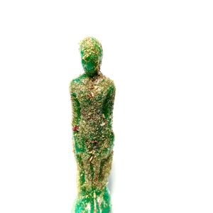 A green statue made of plastic and grass.