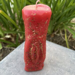 A red candle sitting on top of a table.