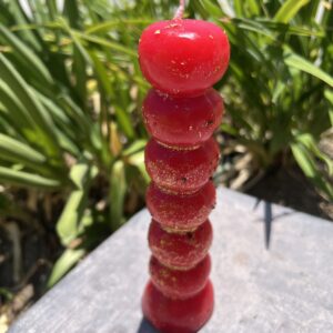 A stack of red candles on top of a table.