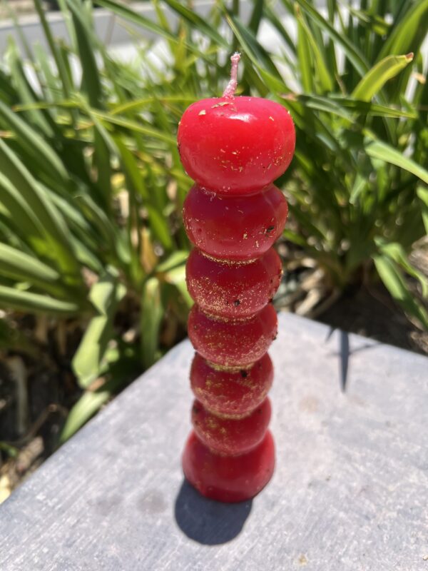 A stack of red candles on top of a table.