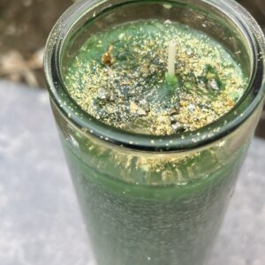 A green smoothie in a glass on the table.