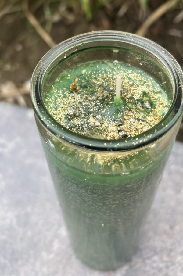 A green smoothie in a glass on the table.