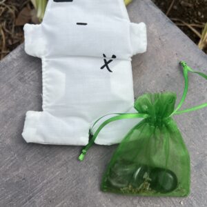 A white bag with green string and a small bag