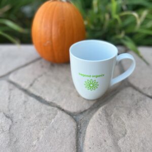 A coffee cup sitting on top of a brick floor.