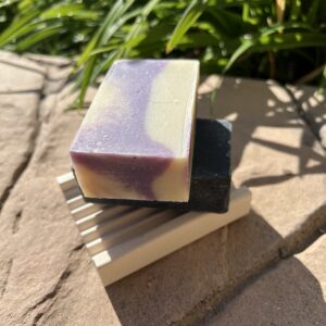 A soap sitting on top of a wooden holder.