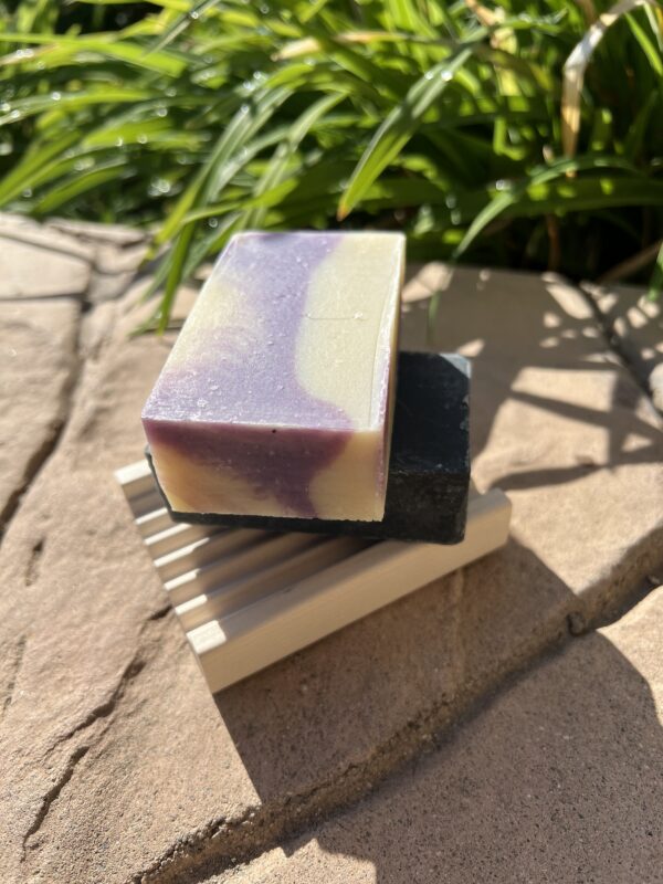 A soap sitting on top of a wooden holder.