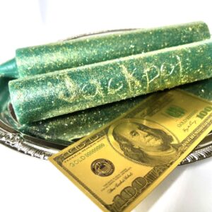 A close up of a dollar bill and some green wax