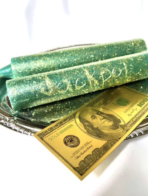 A close up of a dollar bill and some green wax