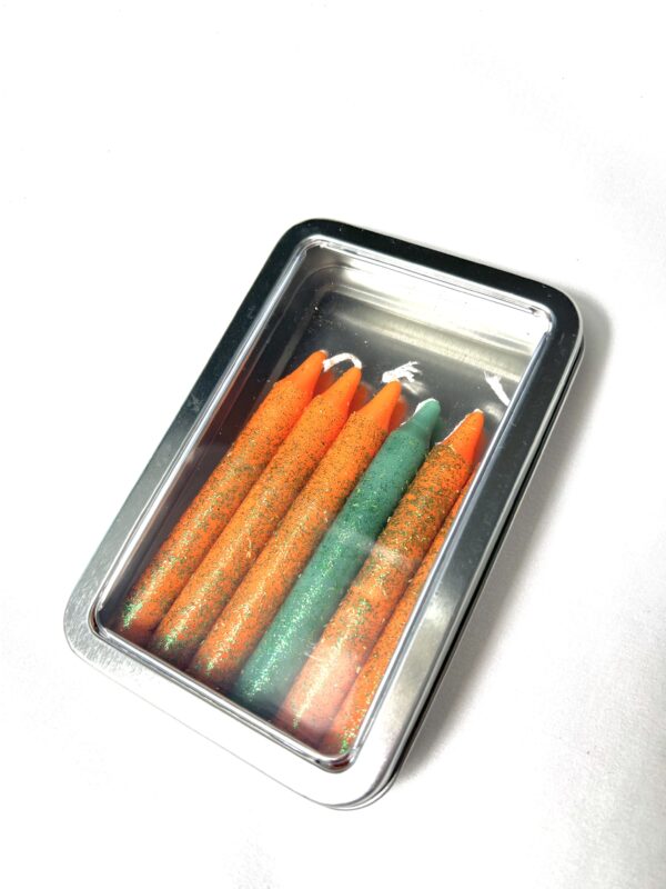 A box of colored pencils in the middle of a table.