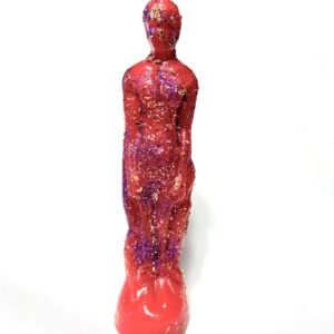 A red statue with purple and pink paint on it.